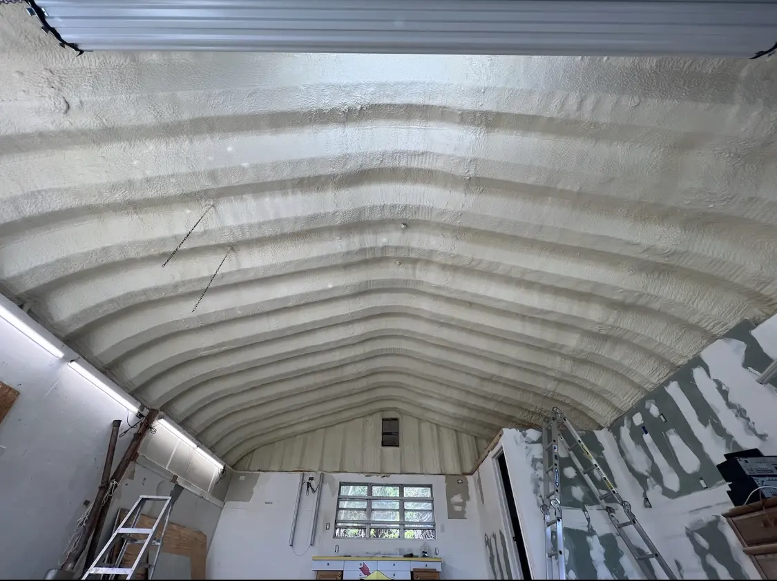 Spray polyurethane foam applied to the underside of a metal roof deck in Northvale